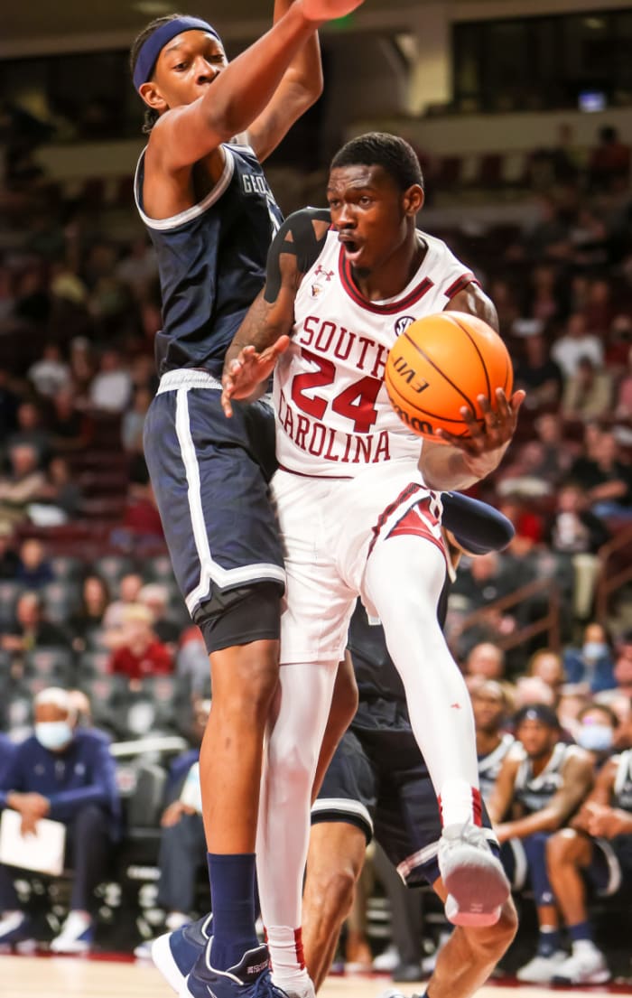 South Carolina Gamecocks forward Keyshawn Bryant (24) passes around Georgetown Hoyas center Ryan Mutombo (21) in the first half at Colonial Life Arena. The 80-67 win was part of a late fall hot streak where the Gamecocks won 7-of-8 with wins over Western Kentucky, UAB and Florida State in addition to the Hoyas.